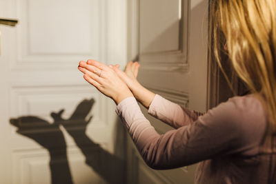 Side view of woman with hands in hair