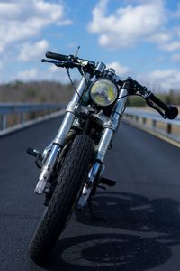 Close-up of bicycle on road against sky
