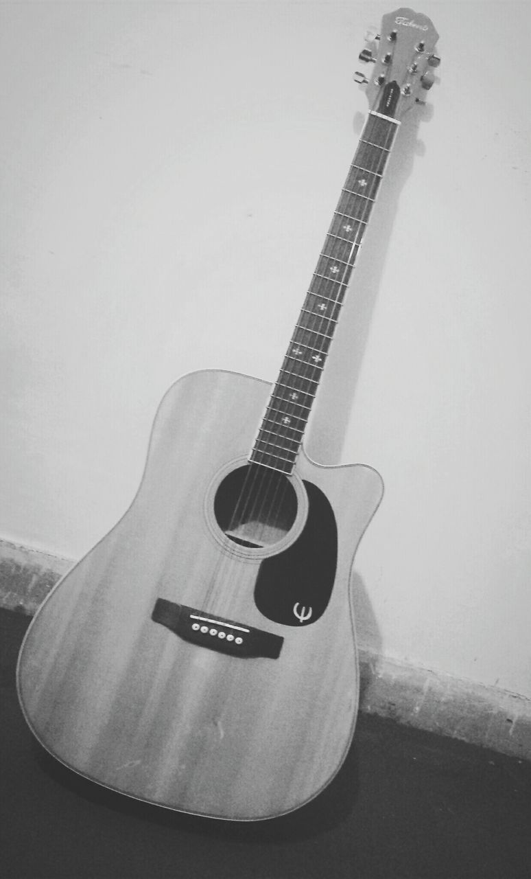 technology, music, indoors, metal, communication, low angle view, still life, musical instrument, close-up, guitar, single object, no people, arts culture and entertainment, lighting equipment, wall - building feature, equipment, musical instrument string, retro styled, musical equipment, high angle view