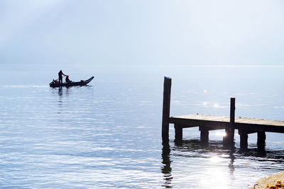 People on sea against sky