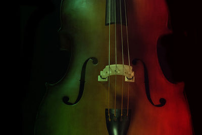Close-up of guitar against black background