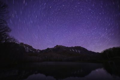 Scenic view of lake against sky at night