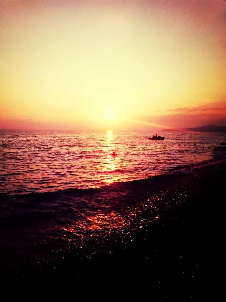 sunset, sea, water, horizon over water, scenics, tranquil scene, orange color, sun, beauty in nature, tranquility, idyllic, silhouette, sky, nature, beach, nautical vessel, reflection, shore, boat, rippled