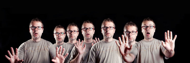 Multiple image of man gesturing against black background