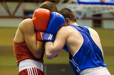 Men boxing in ring