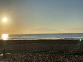 Scenic view of beach against sky during sunset