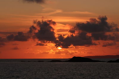 Scenic view of sea against romantic sky at sunset