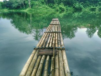 High angle view of wooden post in lake against sky