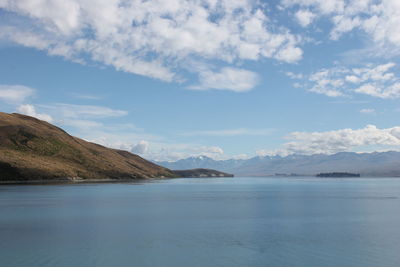 Scenic view of sea and mountains against sky