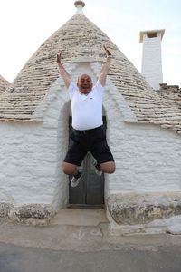 Full length of man standing against built structure