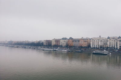 River and buildings against clear sky