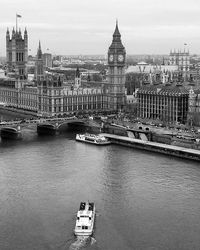 Boats in river with buildings in background