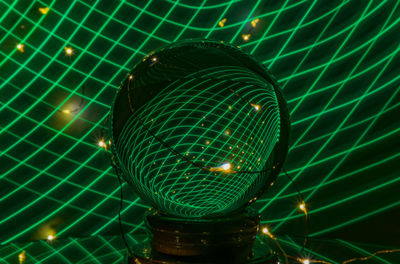 Low angle view of illuminated lights against sky at night