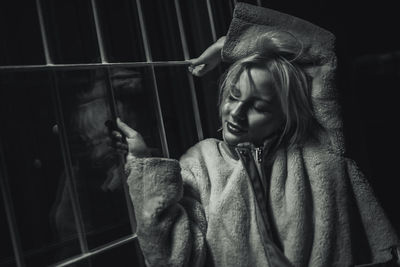 Portrait of girl looking through window