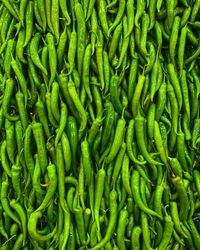 Full frame shot of green chili peppers at market