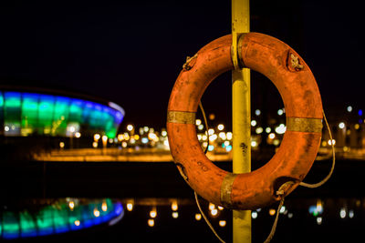 Close-up of illuminated boat in city at night