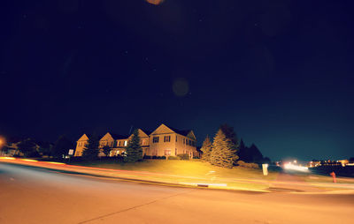 View of illuminated street lights at night