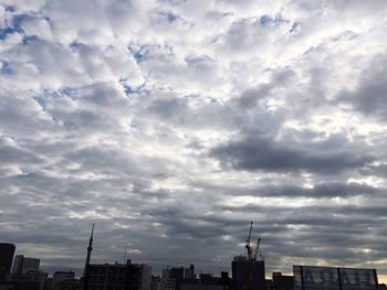 High section of cityscape against cloudy sky