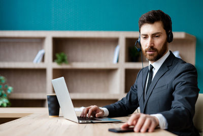 Portrait of businessman working at desk in office