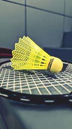 Close-up of yellow guitar on table