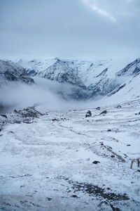 Scenic view of snow covered mountains against sky