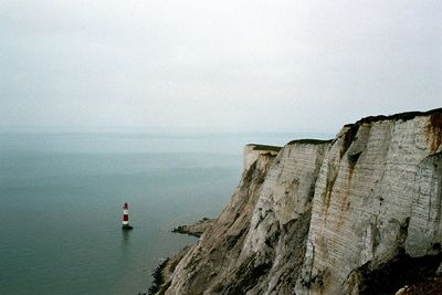 Scenic view of sea with mountain range in background