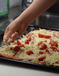 Cropped hand of person preparing food