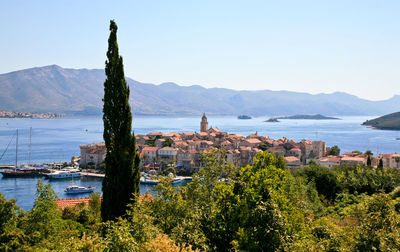 Scenic view of sea and buildings against clear sky