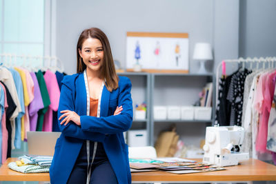 Portrait of young woman standing in office