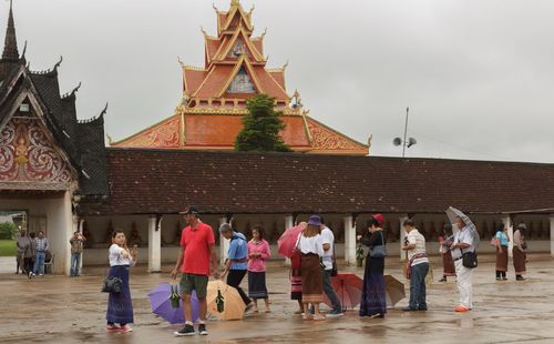 People at temple against sky