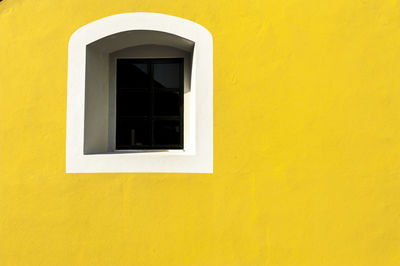 Close-up of window of yellow building