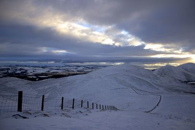 Scenic view of snow covered landscape against sky