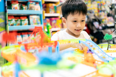 Portrait of cute boy looking at store