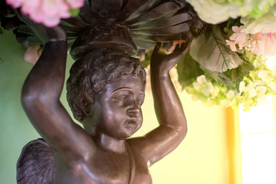 Low angle view of statue against red wall