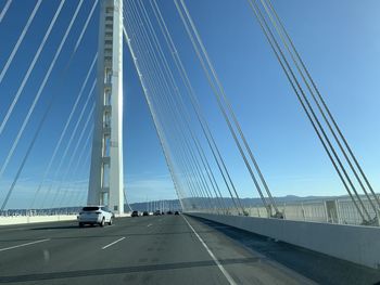 Low angle view of suspension bridge against sky