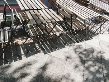 High angle view of empty tables and chairs at sidewalk cafe