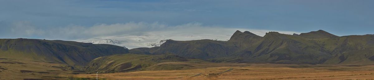 Panoramic view of snowcapped mountains against sky