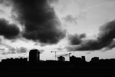 Low angle view of buildings against cloudy sky