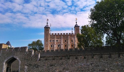 Low angle view of historical building against cloudy sky