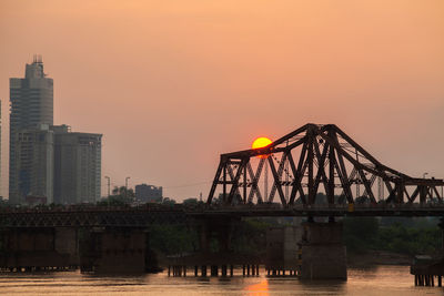 Bridge over river during sunset