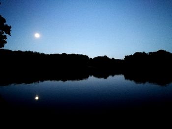 Reflection of trees in calm lake