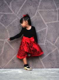 Girl standing against the wall