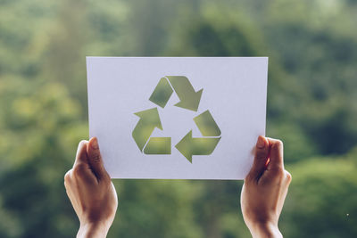 Close-up of hand holding paper