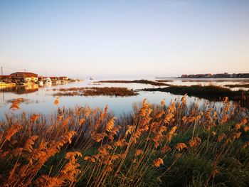 Scenic view of lake against sky during sunset