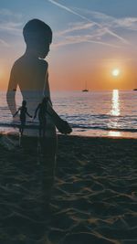 Multiple image of people standing at beach against sky during sunset