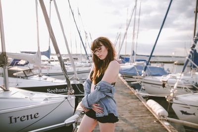 Young woman standing at harbor