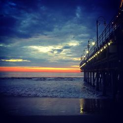 Pier on sea at sunset