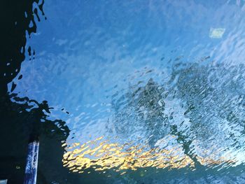 Close-up of water drops against sky