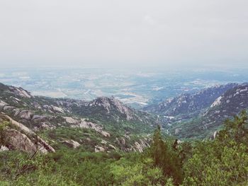 High angle view of valley and mountains against sky