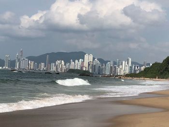 Sea and buildings against sky